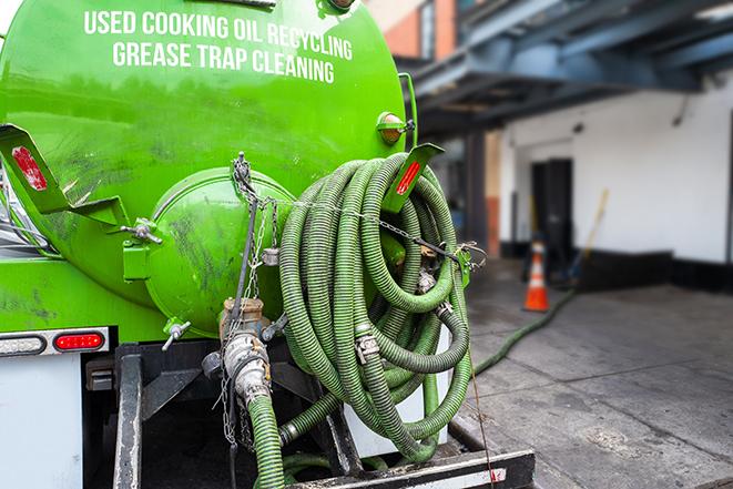 grease trap being pumped out by service technician in Dickson City, PA